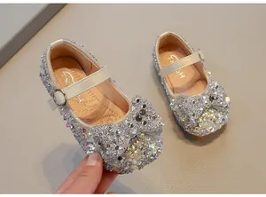 Detail view of sparkly girls rhinestone princess shoes with elegant bow decoration