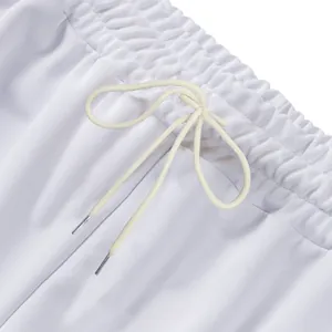 Close-up detail of white heavyweight sweatpants elastic waistband and metal tip drawstring