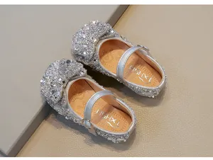 Close-up of sparkling silver rhinestone girl's Mary Jane shoes for performance and parties