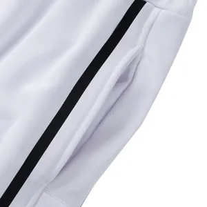 Close-up of pocket detail and black side stripe on white heavyweight sweatpants