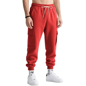 Close-up of red heavyweight men's cargo sweatpants featuring white drawstring and pockets