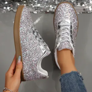 Detail view of silver glitter sneakers showing sparkling texture and comfortable flat sole