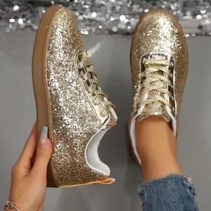 Macro view of sparkly gold glitter texture on a casual lace-up sneaker for women