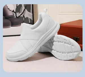 Detail of white breathable slip-on sneakers showing side profile and non-slip sole texture
