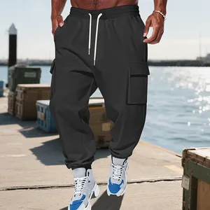 Men's heavy-duty black cargo pants with multiple pockets shown in an outdoor dock setting.