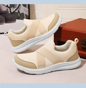 Side view of cream breathable mesh slip-on sneakers with elastic cross straps