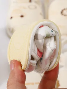 Detailopname van de flexibele zachte zool van een babywandelsandaal die wordt opgevouwen