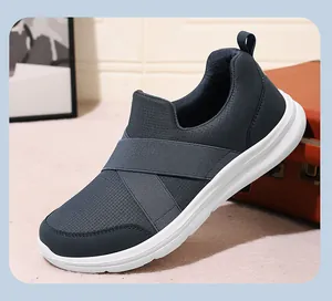 Macro view of breathable navy mesh slip-on shoes featuring durable elastic cross straps