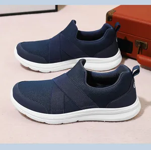 Close-up detail of navy blue breathable mesh slip-on sneakers with elastic cross straps