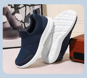 Side view of navy blue mesh slip-on sneakers featuring elastic cross straps and white sole