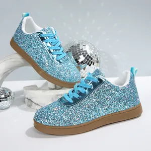 Detailed shot of sparkling blue glitter women's flat sneakers for casual wear
