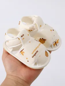 Detailweergave van zachte crème babysandalen met biologisch katoen en egelpatroon.