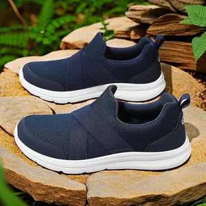 Breathable navy blue mesh slip-on sneakers for men with white soles on natural rocks