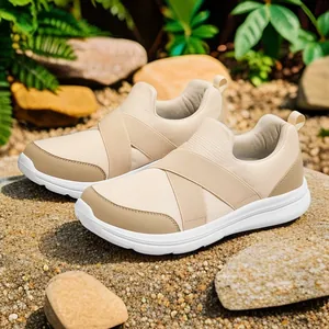 Comfortable beige mesh slip-on sneakers with elastic cross bands for daily casual wear