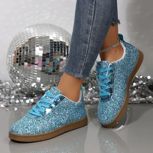 Detailed close-up of blue glittery flat sneakers for women in a stylish party setting