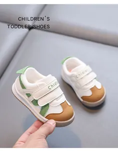Close-up detail of lightweight mesh toddler walking shoes held by hand over sofa