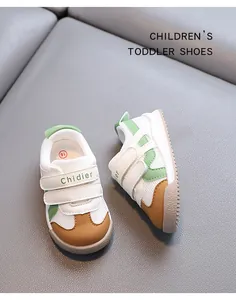 Close-up of breathable mesh toddler shoes with green accents and velcro straps