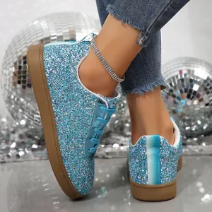 Close-up of sparkling blue glitter flat sneakers for women in a disco theme setting