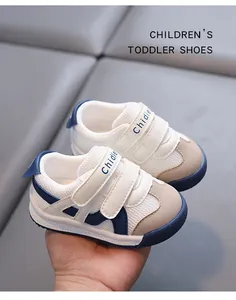 Close-up detail of breathable white toddler walking shoes with blue soles and straps.
