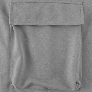 Close-up detail of a functional grey cargo pocket on heavyweight cotton joggers.