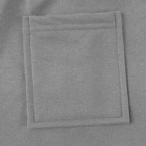 Close-up detail of a sturdy stitched square pocket on grey heavyweight cotton cargo pants