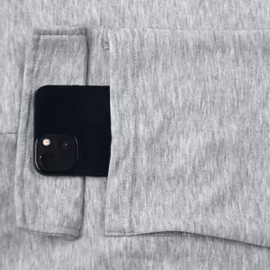 Detail view showing a large pocket on grey heavyweight cargo sweatpants for men.