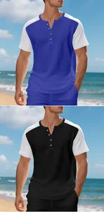 Detail view of men's waffle Henley t-shirt in blue and black patchwork design.