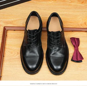 Detailed view of retro black horse leather Derby shoes on wooden background with bow tie