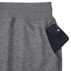 Detail shot of men's grey sweatpants showing elastic waistband and a side phone pocket