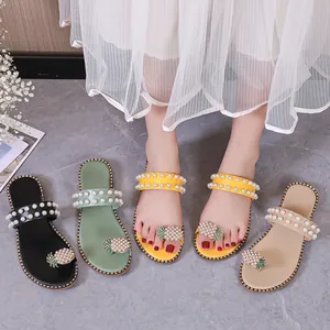 Detailed view of summer flat sandals with pearl pineapple decor in multiple colors