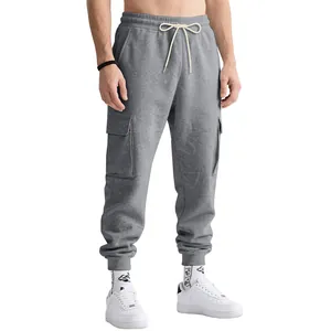 Close-up of grey heavyweight cargo joggers with elastic waist and side pockets on a model.