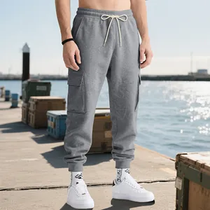 Detail view of grey heavyweight cargo joggers for men with a multi-pocket high street design