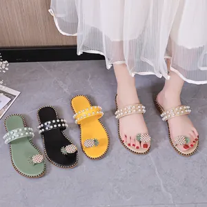 Detail view of pineapple rhinestone and pearl decorated flat sandals in four colors