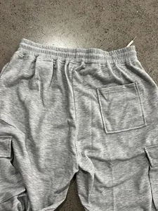 Detail of men's grey heavy weight cargo sweatpants showing waistband and rear pocket.