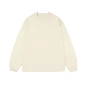 Front flat lay of a minimalist cream-colored long-sleeve cotton T-shirt with ribbed cuffs