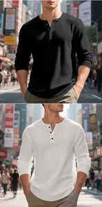 Close-up of black and white waffle knit Henley shirts with textured square jacquard.