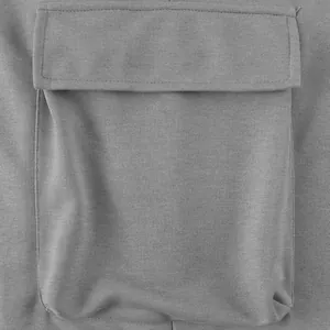 Detailed view showing the square flap cargo pocket on gray French terry cotton pants