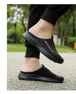 Close-up detail of breathable black mesh slip-on mules with a lightweight soft rubber sole