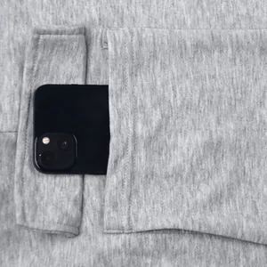 Close-up of men's fleece cargo pants showing a large functional pocket for phone storage