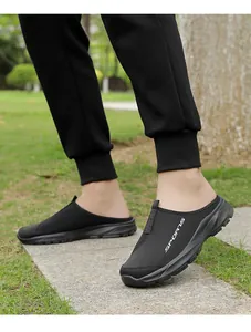 Detailed view of black breathable mesh slip-on mules for men in an outdoor setting