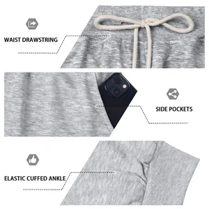 Detail view of grey sweatpants showing drawstring waist, side pockets, and elastic cuffs.