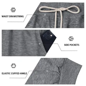 Detail of grey sweatpants showing drawstring waist, side pockets and elastic cuffed ankles