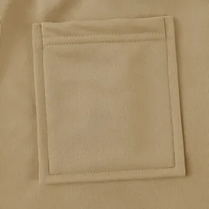 Detail shot of the square patch pocket and heavy knit fabric of the khaki work pants