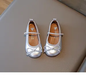 Detailed view of silver girls princess flat shoes with delicate bow and elastic strap