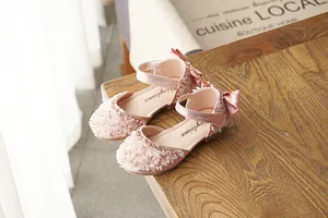 Elegant pink sequined princess shoes for girls featuring a bow detail and soft soles for comfort