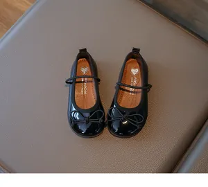 Detailed top view of black patent leather girls Mary Jane shoes with cute bow design