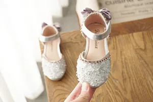 Detailed view of silver girl's princess shoe featuring sparkling crystal embellishments