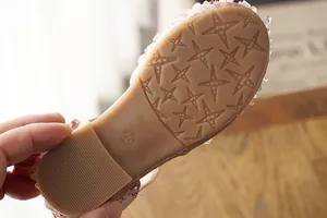Detailed view of non-slip star patterned sole of girls' princess sandals size 26