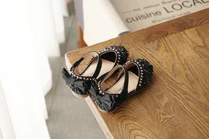 Elegant black dress sandals for girls featuring sparkling rhinestones and a large heel bow