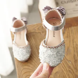 Sparkling silver girls' princess dress shoes with crystal rhinestones and a silk bow